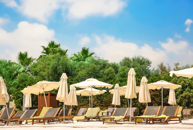 Sunbeds on beach in sunny day