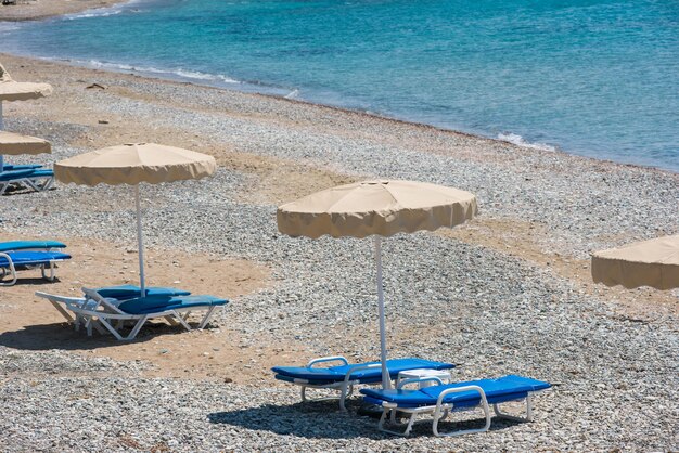 Sunbeds and umbrellas on the beach Seaside tropical resort