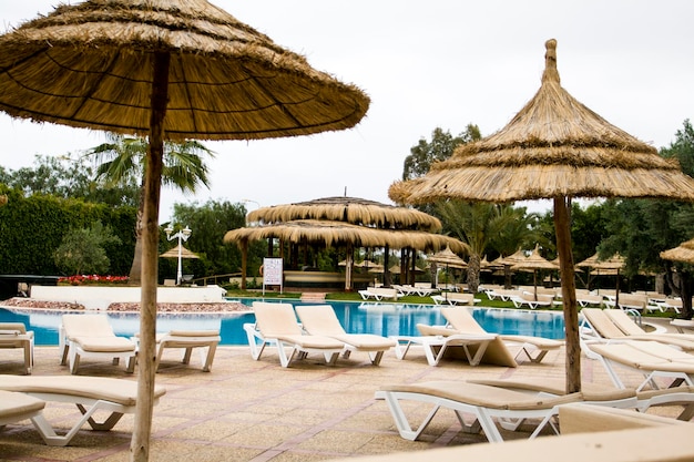 Photo sunbeds and umbrellas by the pool at one of the resorts