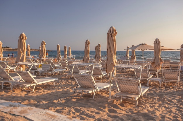 Sunbeds and umbrellas on Modica's beach at sunset