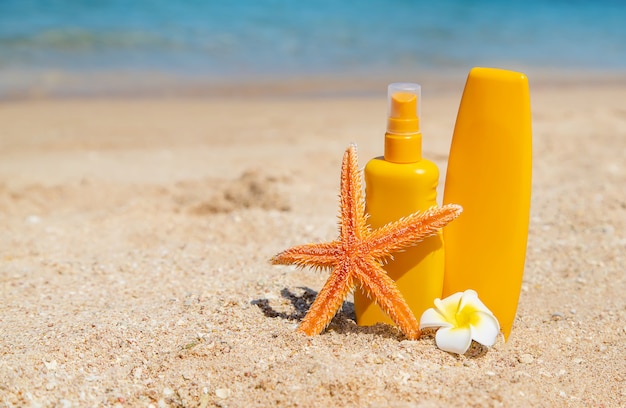 Sunblock on the beach. Sun protection. Selective focus.