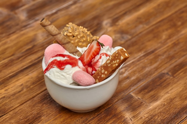 Sundae ice cream cocktail in bowl with wafer and candy