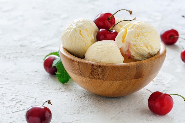 Sundae with sweet cherry in a wooden bowl