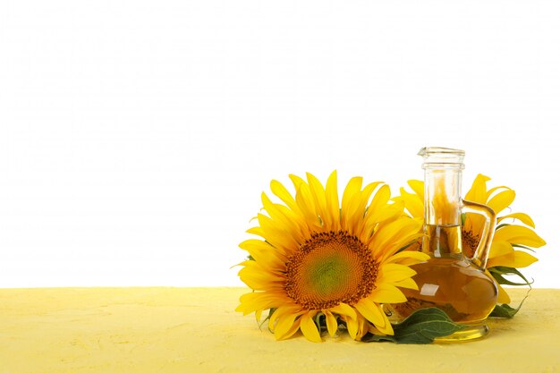 Sunflower and glass jar of oil isolated