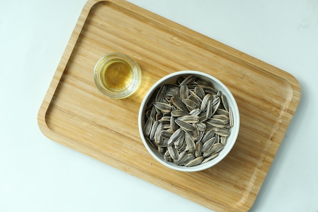 Sunflower oil seed and oil in a container on table