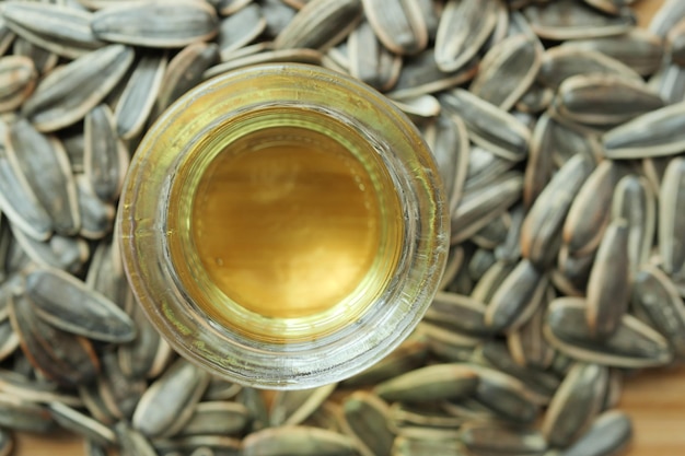 Sunflower oil seed and oil in a container on table