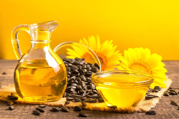 Sunflower oil and sunflower seeds on yellow background. organic and eco food concept. healthy food a