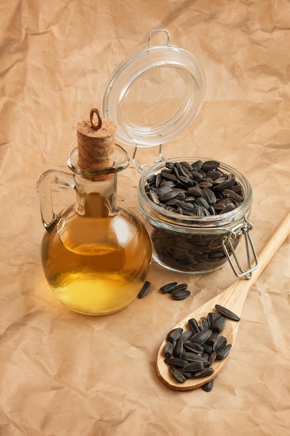 Sunflower oil with a bag of seeds and a wooden spoon