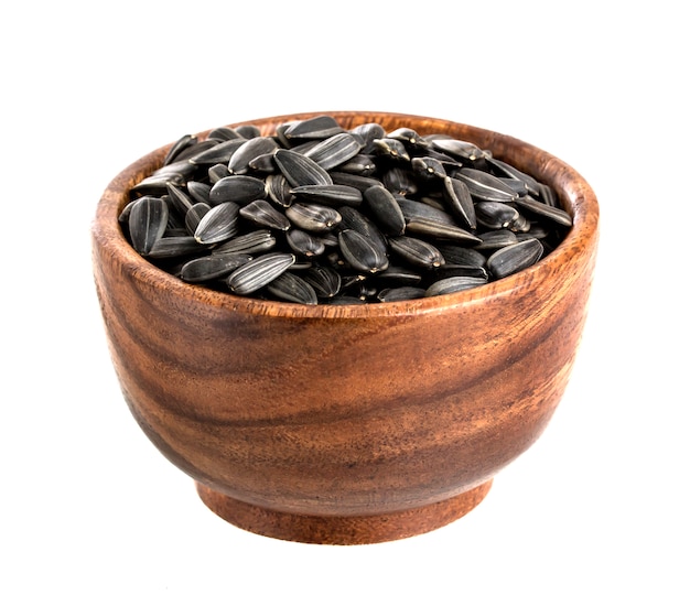 Sunflower seeds in bowl, isolated on white