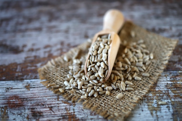 Sunflower seeds in a wooden spatula.