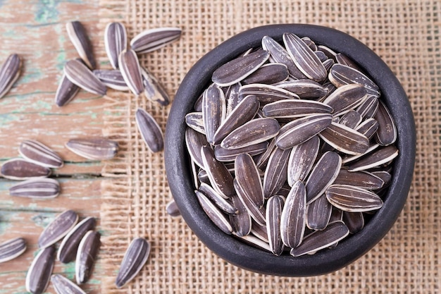 Sunflower seeds on the wooden table Helianthus annuus