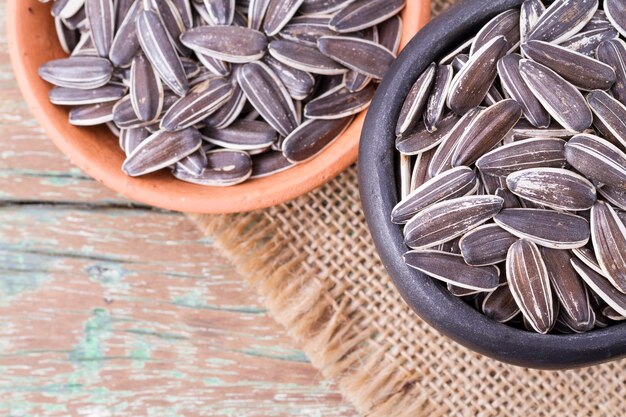 Sunflower seeds on the wooden table Helianthus annuus