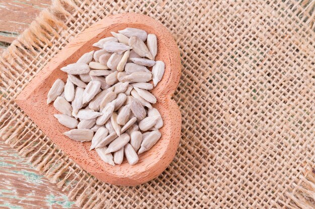 Sunflower seeds on the wooden table Helianthus annuus