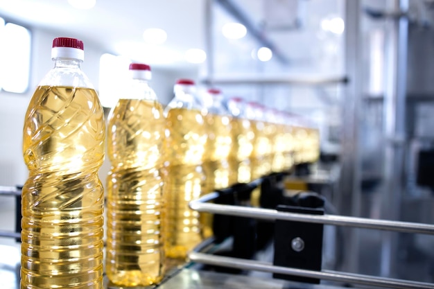 Sunflower vegetable oil in bottles being produced in food factory