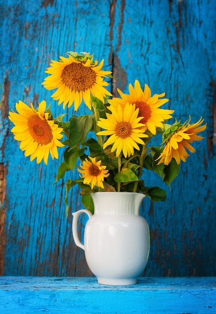 Sunflowers in a vase on a wooden table