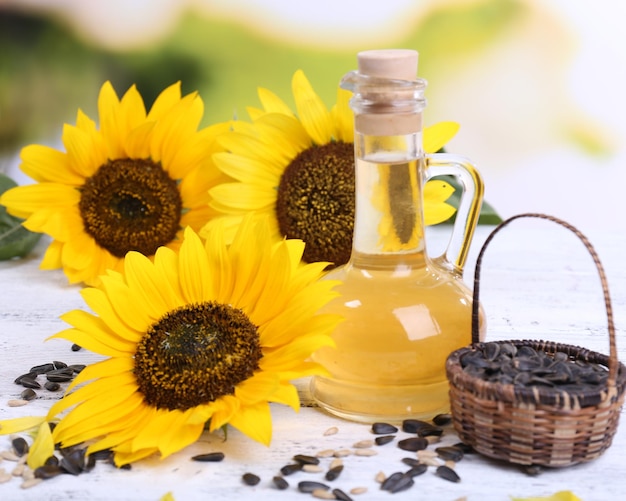 Sunflowers with seeds and oil on table closeup