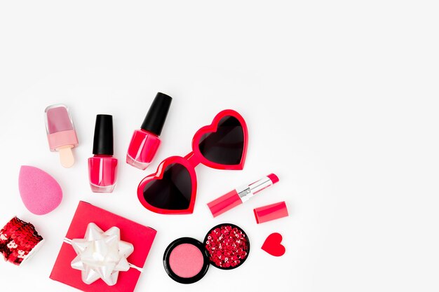 Sunglass, gift and cosmetics on a white background. Valentines day consept. Flat lay, top view