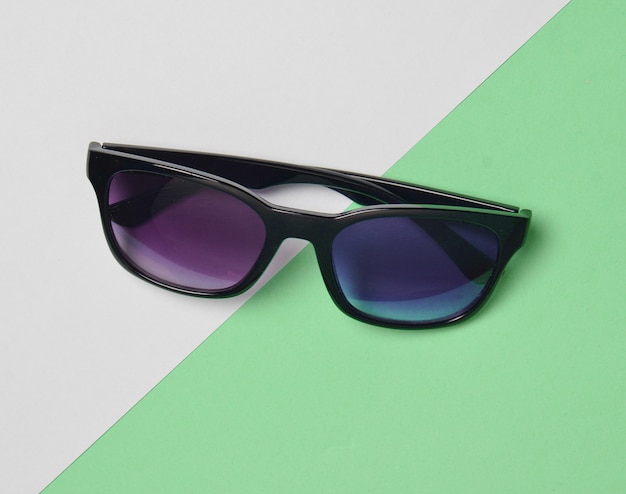 Sunglasses on a colored pastel.