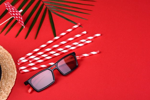 Photo sunglasses and green leaf on a colored surface