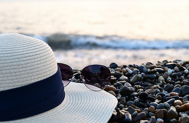 Sunglasses and hat on the beach the concept of travel