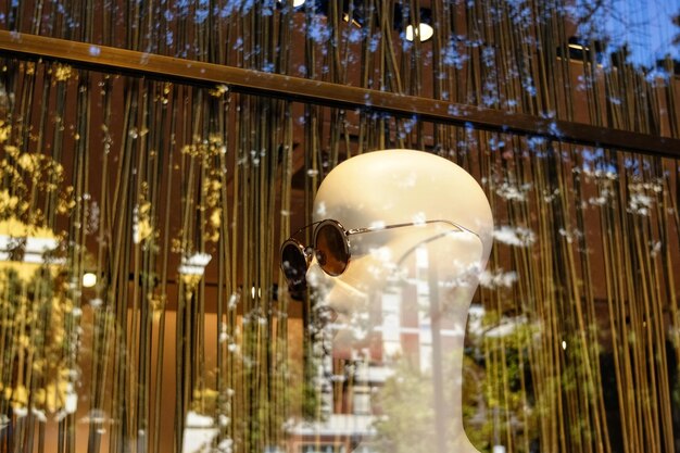 Photo sunglasses on mannequin seen through window