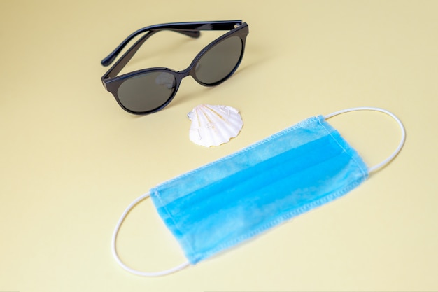 Sunglasses, medical face mask, seashell