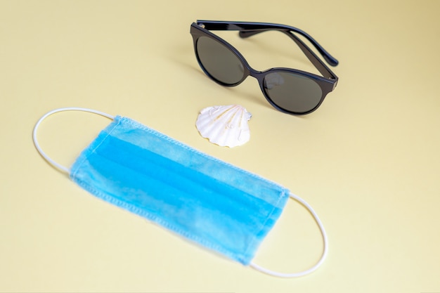 Sunglasses, medical face mask, seashell