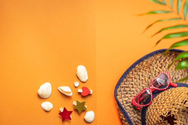 Sunglasses and seashells with hat, summer concept background