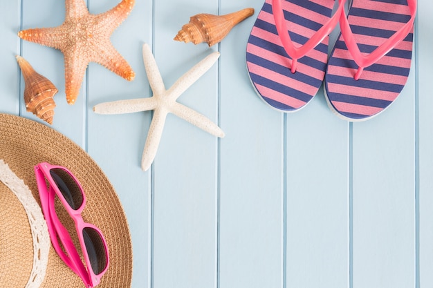 Sunglasses and starfish on the blue wooden floor