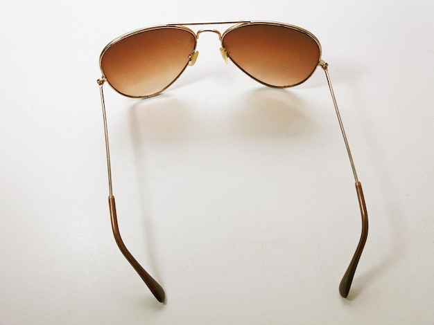 Sunglasses on white background for summer sea