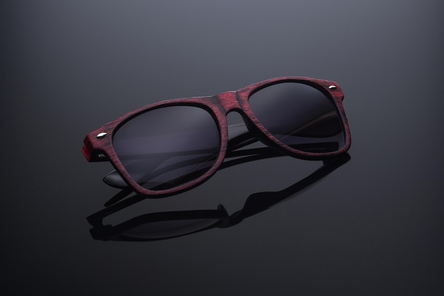 sunglasses in a wide brown frame on a black background