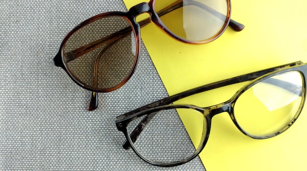 Photo sunglasses with brown glasses in an iron frame on a gray background