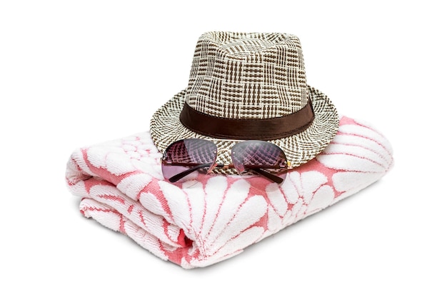 Sunglasses with summer hat and towel on white