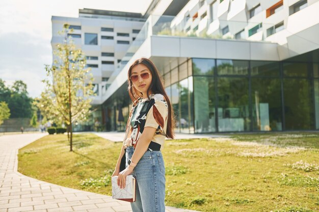 In sunglasses Young asian woman is outdoors at daytime