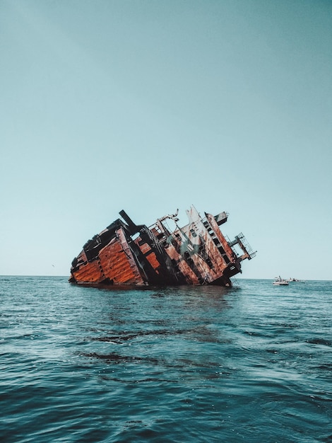 Photo sunken rusty ship on cape