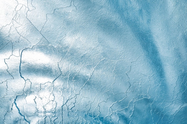 Sunlight passes through a thick layer of ice and creates a beautiful pattern. Ice texture