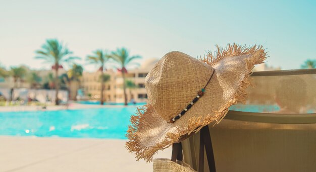 Sunlounger and a hat near the pool