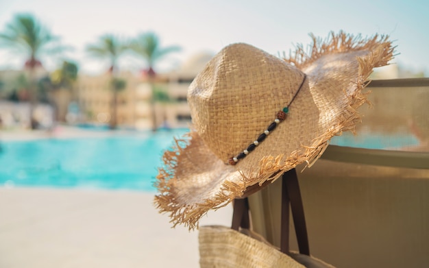 Sunlounger and a hat near the pool