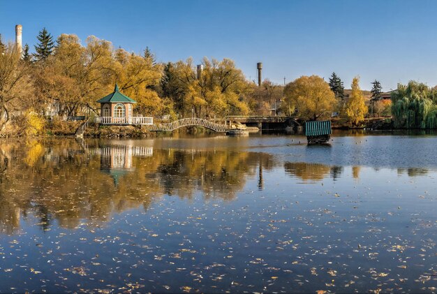 Photo sunny autumn evening on the blue lake with yellow trees the ivanki village in ukraine