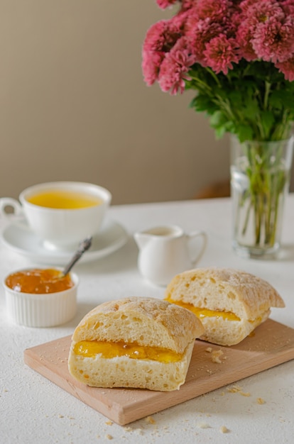 Sunny breakfast. toast with orange jam and tea. Homemade food.