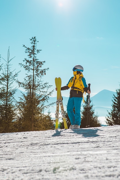 Sunny day at ski slope woman skiing winter activities