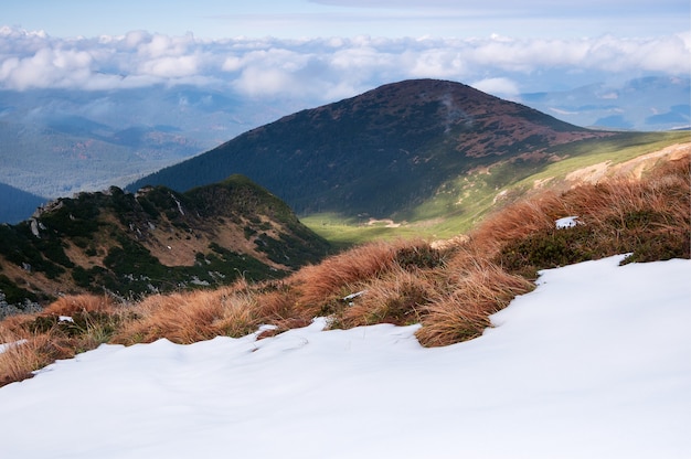 Sunny day with cumulus clouds at the mountains