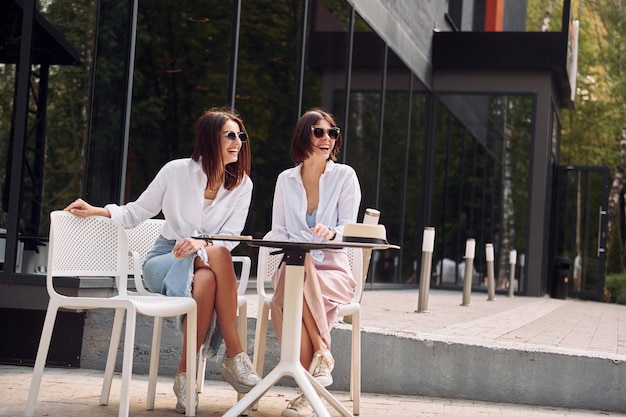 At sunny daytime two female friends have great weekend outdoors\
together