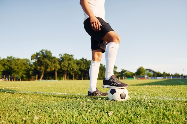 Sunny daytime Young soccer player have training on the sportive field