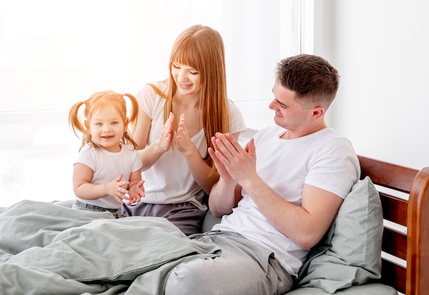 Sunny family morning in the bed