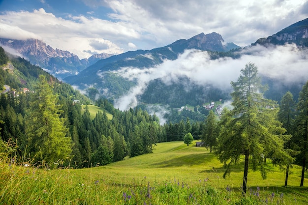 Sunny Mountains Landscape with big peaks of Dolomites whith blue sky and grass valley Alps Italy Europe