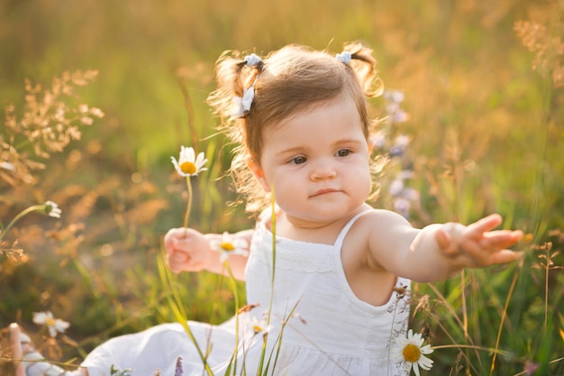 Photo sunny photo of a girl among dandelions in a field 3009