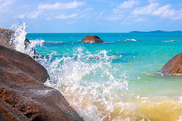 Sunny sea landscape the sea with a rocky shore the waves break\
on the rocks