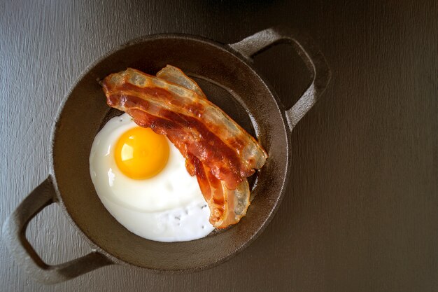 Sunny side up egg with fried bacon