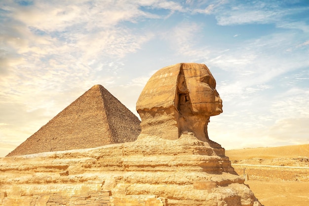 Sunny sunet over sphinx and pyramid in egypt